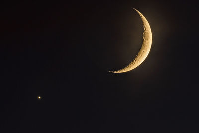 Low angle view of moon in sky at night