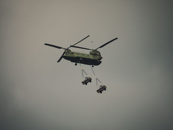 Low angle view of helicopter flying in sky