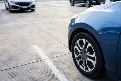 Close up of modern car in parking lot, grunge surface of street, car parked in the right position