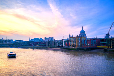 Scenic view of river against cloudy sky