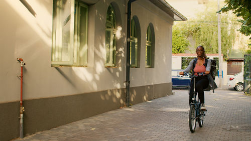 Side view of man riding bicycle on street