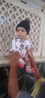Full length of cute baby girl holding indoors