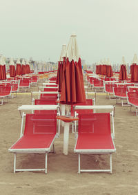 Chairs on beach against clear sky