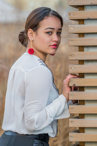 Portrait of young woman posing outdoors