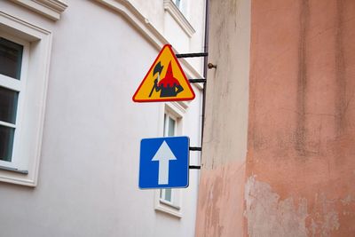 Low angle view of road sign against building