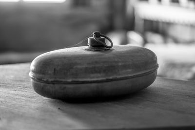 Close-up of old container on table