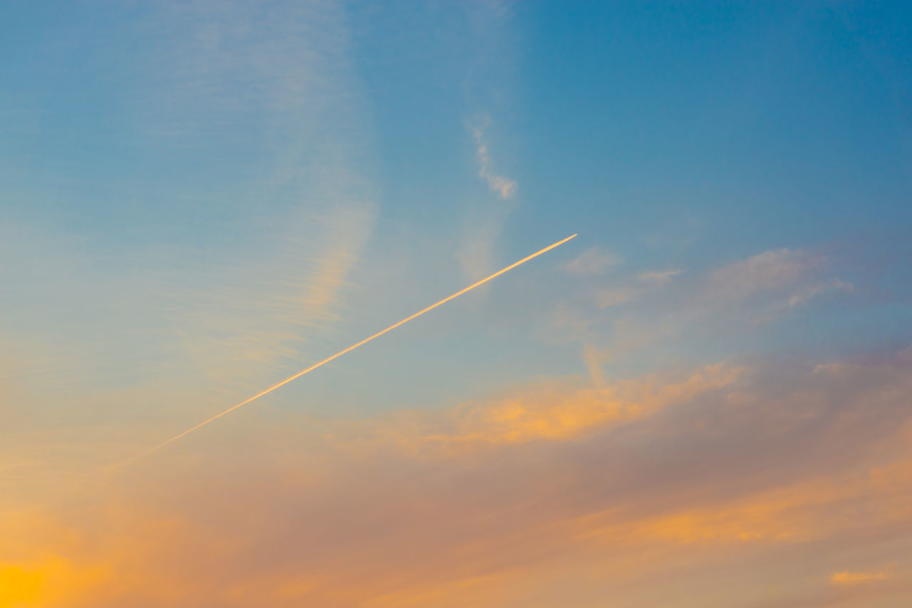 LOW ANGLE VIEW OF VAPOR TRAIL AGAINST SKY DURING SUNSET