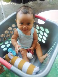 High angle portrait of cute baby sitting outdoors