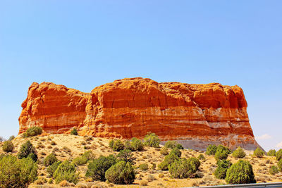 Rock formations on mountain against clear blue sky