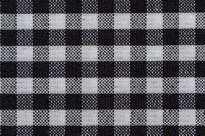 Checkered fabric background. black cell. top view, flat lay.