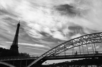 Low angle view of arch bridge against cloudy sky