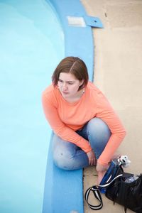 Young woman sitting on bicycle
