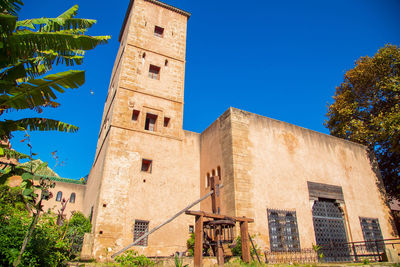 Low angle view of building against clear blue sky