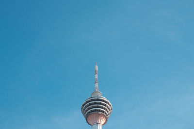 Low angle view of communications tower against clear blue sky