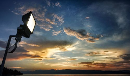 Low angle view of silhouette camera against sky during sunset