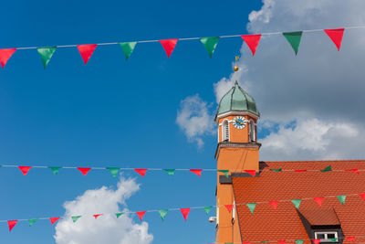 Low angle view of flags hanging against building