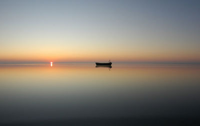 Scenic view of sea against clear sky during sunset