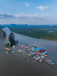 High angle view of city by sea against sky