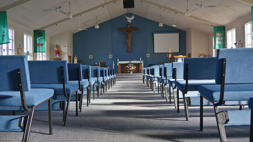 Empty chairs and tables in room