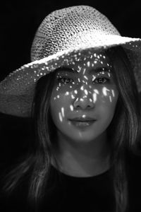Close-up of young woman wearing hat