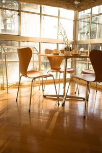 Empty chairs and table in room