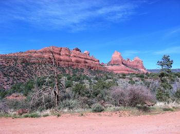Rock formations on landscape against sky