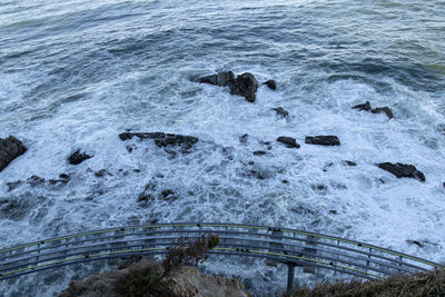 High angle view of rocks on sea shore