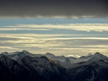 Scenic view of snowcapped mountains against sky during sunset