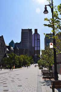 Street amidst buildings in city against sky