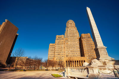 Low angle view of buildings against blue sky