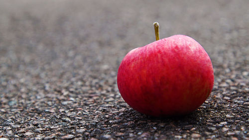 Close-up of apple on ground