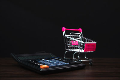 Close-up of telephone booth on table against black background