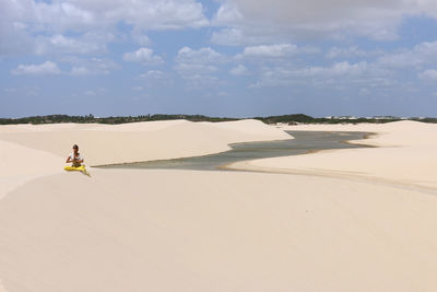 Young woman relaxing in lencois maranhenses national park, brazil