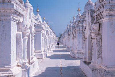 Panoramic view of colonnade and buildings against sky