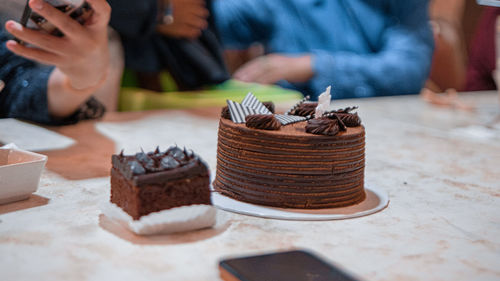 Midsection of woman holding cake