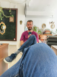 Man sitting on sofa at home