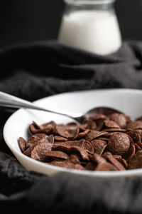 Close-up of coffee beans in bowl on table