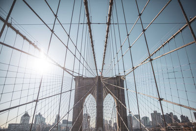 Low angle view of suspension bridge against sky