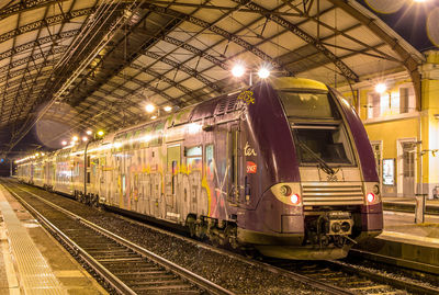 Train at railroad station at night