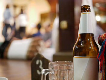 Selective focus of a bottle of opened beer in a khantok dinner, northern thai style meal 