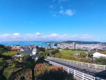 High angle view of cityscape against blue sky