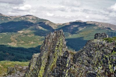 Scenic view of mountains against cloudy sky