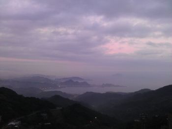 Scenic view of mountains against cloudy sky