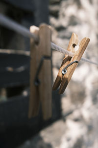 Two clothespins hanging on a clothesline