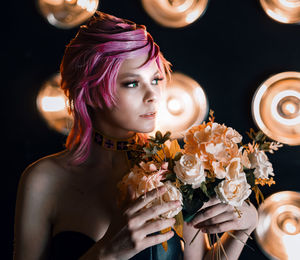 Portrait of young woman holding bouquet