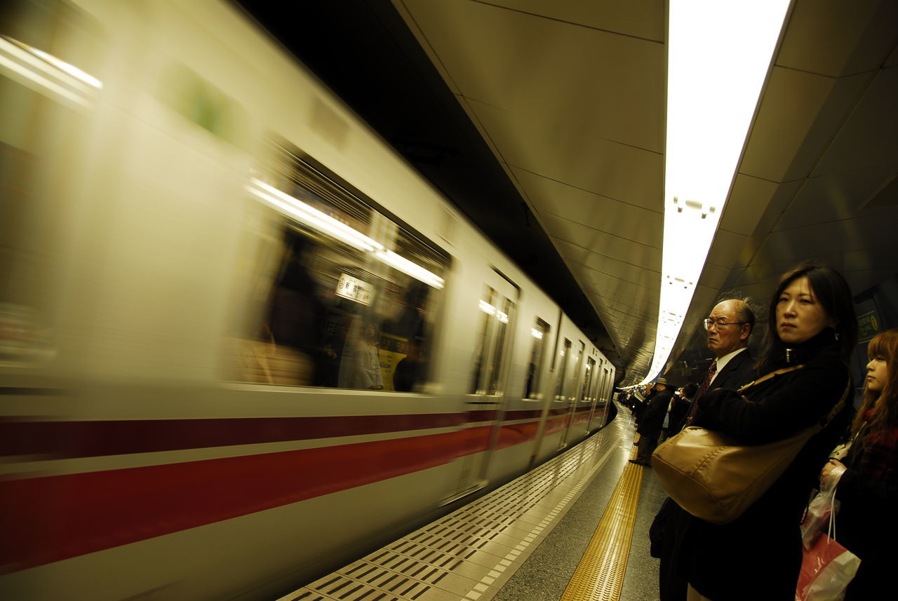 TRAIN ON RAILROAD STATION PLATFORM