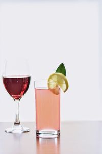 Close-up of wineglass against white background