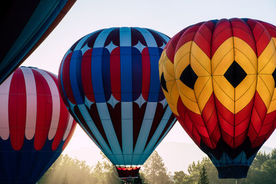 Low angle view of hot air balloons against sky