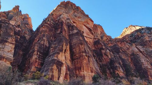 Low angle view of rock formation against clear sky