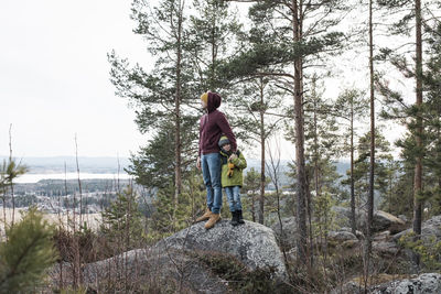 Father and son hiking together enjoying the ocean view